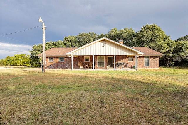 single story home featuring a patio and a front yard