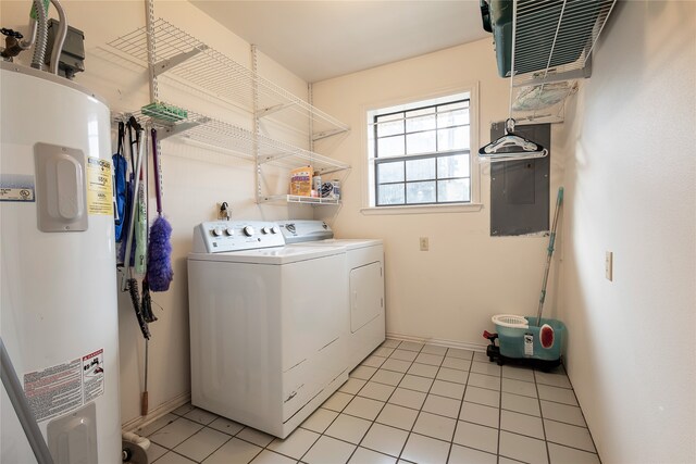 clothes washing area with electric water heater, light tile patterned floors, electric panel, and washing machine and clothes dryer