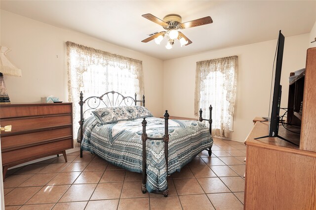 tiled bedroom with ceiling fan