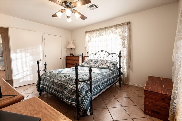 tiled bedroom with ceiling fan