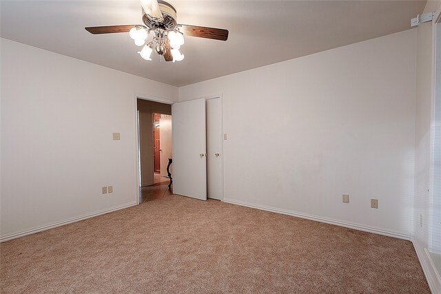 spare room featuring light carpet and ceiling fan