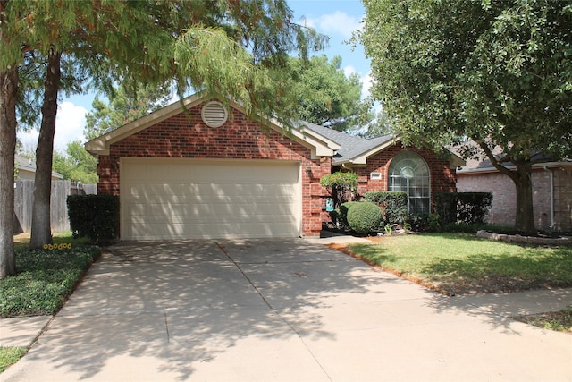 ranch-style house featuring a front yard and a garage