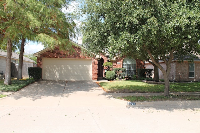 obstructed view of property with a garage and a front yard