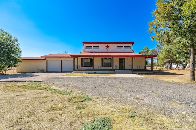 view of front of property with a garage and covered porch