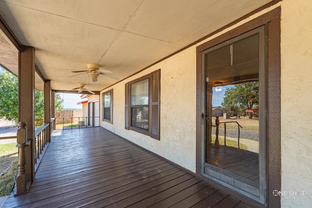 wooden terrace featuring ceiling fan and a porch