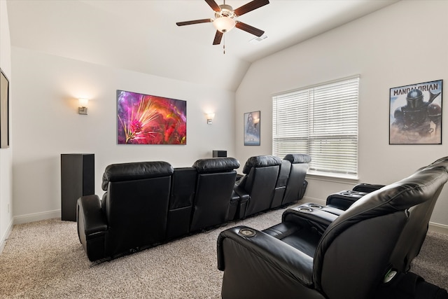 cinema room with vaulted ceiling, light carpet, and ceiling fan