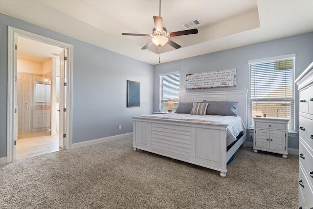 bedroom with multiple windows, ceiling fan, and dark colored carpet