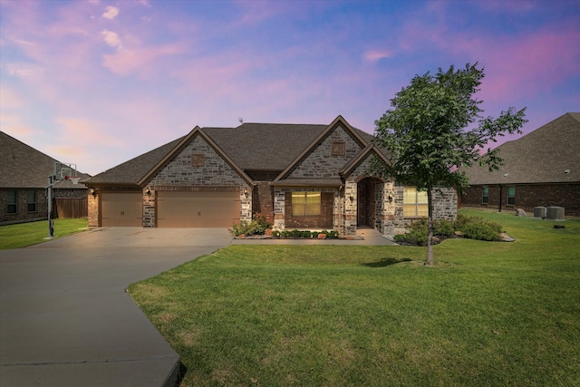 view of front of house with a lawn and a garage