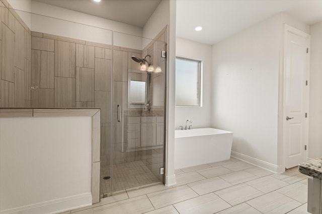 bathroom with shower with separate bathtub