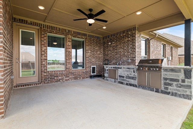 view of patio featuring area for grilling, ceiling fan, and an outdoor kitchen