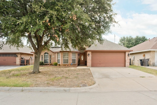 7525 Juliet Ln, Fort Worth, TX 76137 - ranch-style home featuring concrete driveway, a shingled roof, brick siding, and a garage