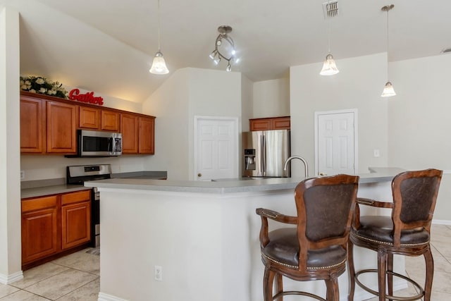 7525 Juliet Ln, Fort Worth, TX 76137 - kitchen featuring appliances with stainless steel finishes, visible vents, brown cabinetry, and light tile patterned floors