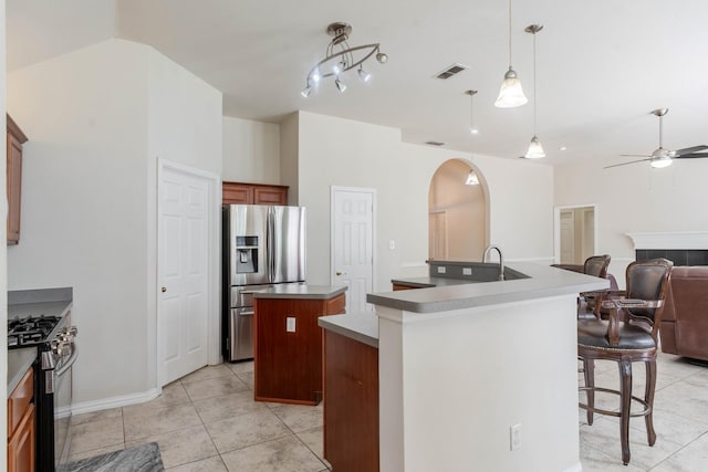 7525 Juliet Ln, Fort Worth, TX 76137 - kitchen featuring open floor plan, visible vents, arched walkways, a large island, and appliances with stainless steel finishes