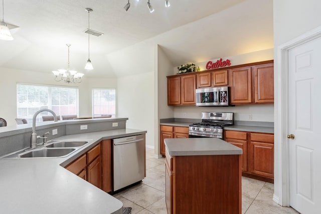7525 Juliet Ln, Fort Worth, TX 76137 - kitchen featuring vaulted ceiling, a sink, appliances with stainless steel finishes, a kitchen island, and light tile patterned flooring