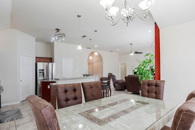 7525 Juliet Ln, Fort Worth, TX 76137 - dining room featuring lofted ceiling, baseboards, visible vents, ceiling fan with notable chandelier, and arched walkways