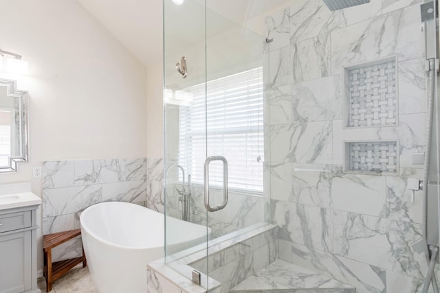 7525 Juliet Ln, Fort Worth, TX 76137 - full bathroom featuring a stall shower, tile walls, lofted ceiling, vanity, and a freestanding tub