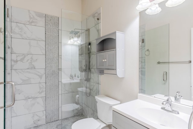 bathroom featuring toilet, a shower with door, and vanity