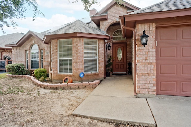 7525 Juliet Ln, Fort Worth, TX 76137 - doorway to property with an attached garage, a shingled roof, brick siding, and a chimney