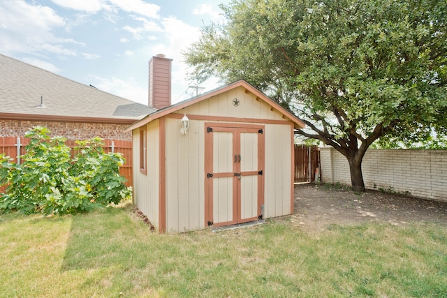 view of outbuilding featuring a lawn