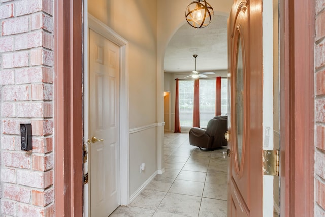 foyer entrance featuring ceiling fan and light tile patterned floors