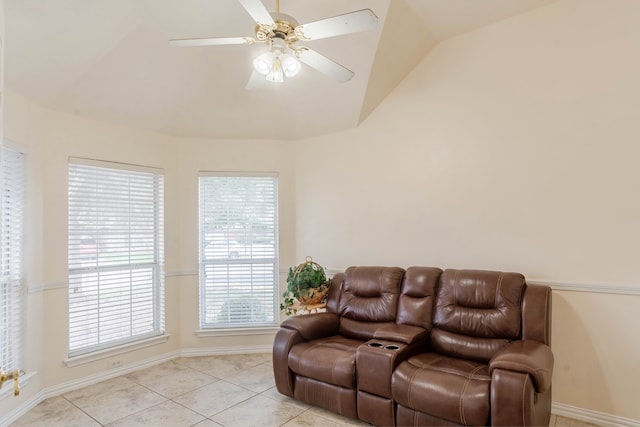 living room featuring lofted ceiling, ceiling fan, and light tile patterned floors