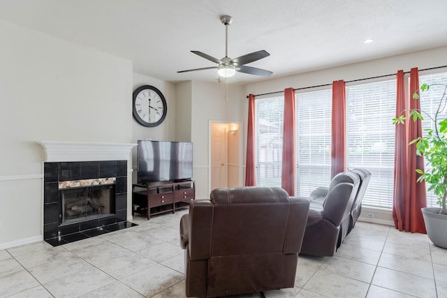7525 Juliet Ln, Fort Worth, TX 76137 - living room with a ceiling fan, a tiled fireplace, light tile patterned flooring, and plenty of natural light