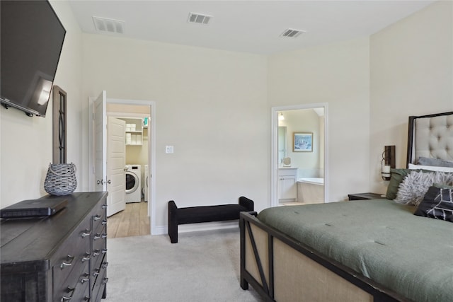 bedroom featuring ensuite bath and light colored carpet