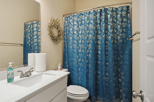 bathroom with walk in shower, toilet, and vanity