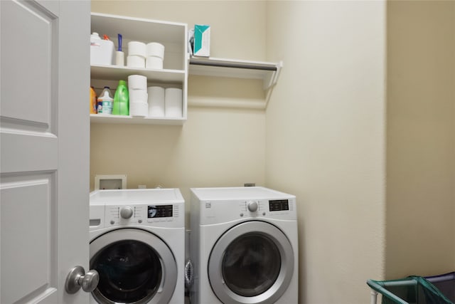 laundry room with washing machine and clothes dryer