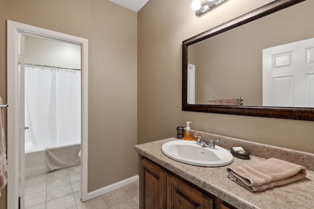 bathroom with tile patterned flooring, shower / bath combo with shower curtain, and vanity