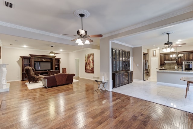 living room featuring crown molding and light hardwood / wood-style floors