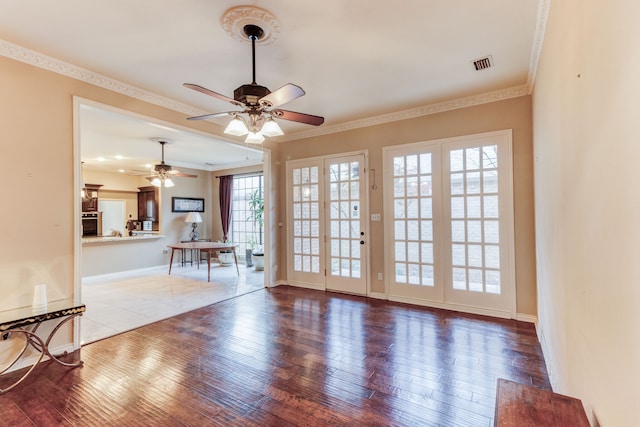 unfurnished living room featuring ornamental molding, ceiling fan, and hardwood / wood-style flooring