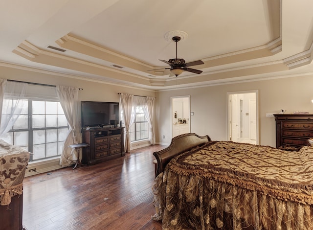 bedroom featuring multiple windows and a tray ceiling