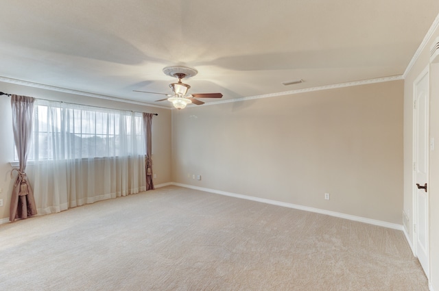 carpeted spare room featuring ceiling fan and crown molding