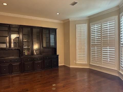 interior space featuring crown molding and dark hardwood / wood-style floors