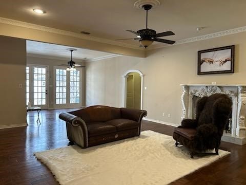 living room with french doors, ceiling fan, dark wood-type flooring, and crown molding