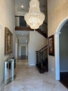 foyer entrance featuring an inviting chandelier