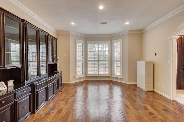 living room featuring light wood-type flooring and ornamental molding