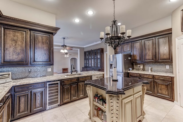 kitchen with stainless steel fridge with ice dispenser, sink, beverage cooler, a kitchen island, and decorative backsplash