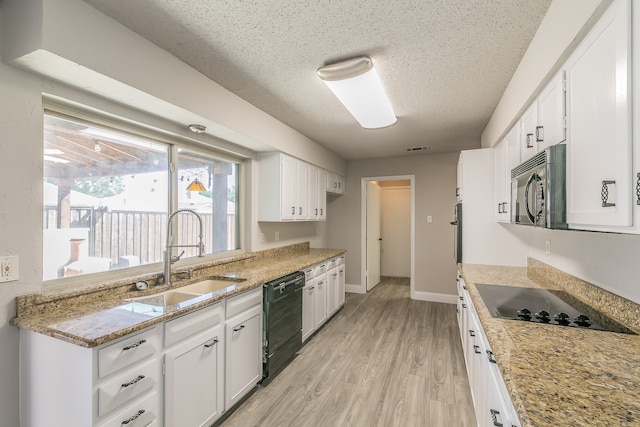 kitchen featuring black appliances, sink, white cabinetry, and light hardwood / wood-style floors