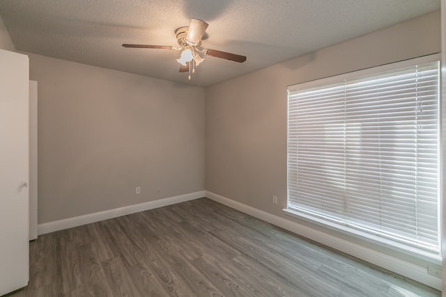 unfurnished room with a textured ceiling, ceiling fan, and hardwood / wood-style floors