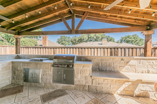 view of patio / terrace featuring exterior kitchen, a gazebo, and area for grilling