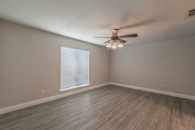 spare room featuring hardwood / wood-style floors and ceiling fan