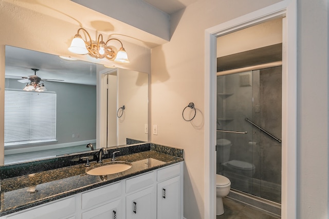 bathroom with vanity, ceiling fan with notable chandelier, walk in shower, toilet, and tile patterned floors