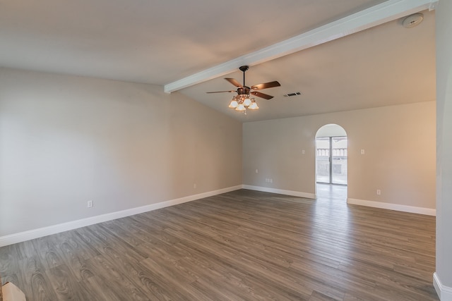 spare room featuring dark hardwood / wood-style flooring, ceiling fan, and vaulted ceiling with beams