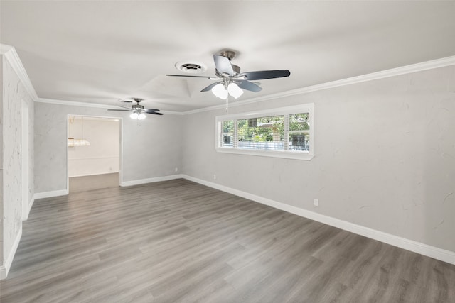 empty room with ornamental molding, wood-type flooring, and ceiling fan