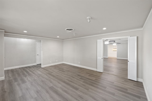 unfurnished room featuring crown molding, hardwood / wood-style flooring, and ceiling fan