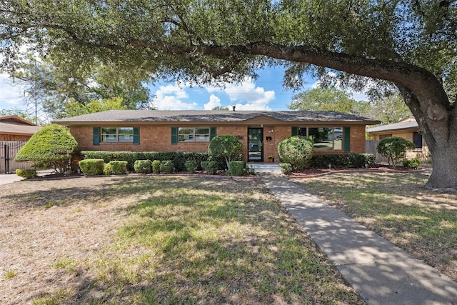 ranch-style home with a front lawn