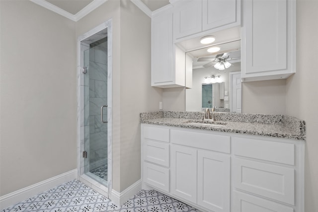 bathroom featuring ceiling fan, an enclosed shower, ornamental molding, and vanity