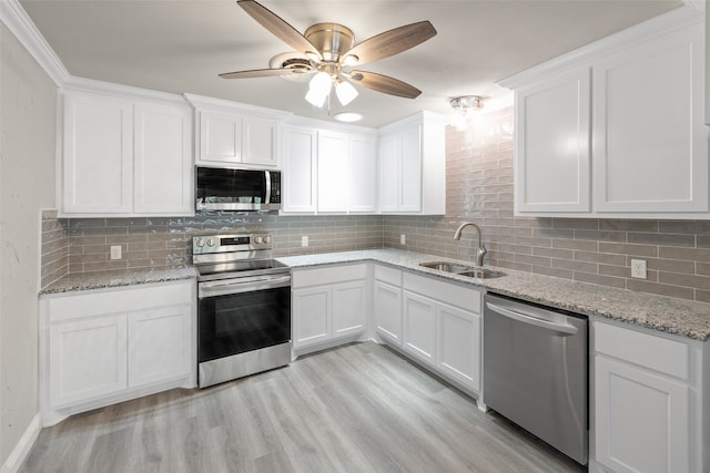 kitchen featuring white cabinetry, stainless steel appliances, sink, and ceiling fan